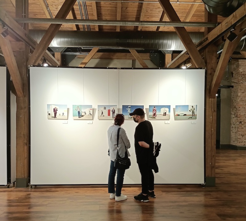 two people looking at photography in gallery