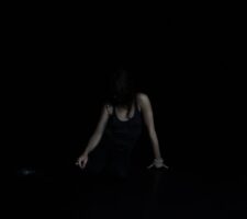 Photo of a performer in the dark