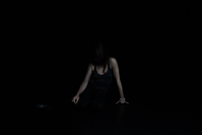 Photo of a performer in the dark