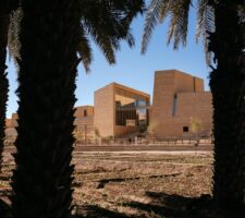 photograph of Diriyah Art Futures building with pam trees in the front