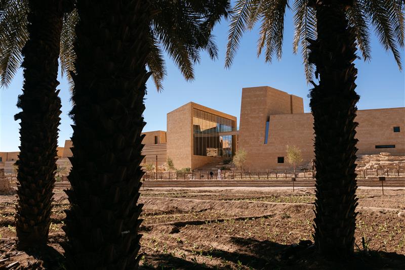 photograph of Diriyah Art Futures building with pam trees